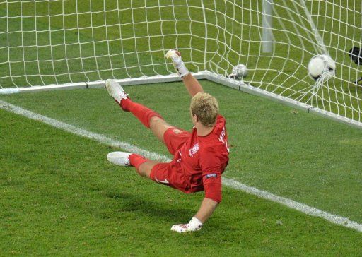 English goalkeeper Joe Hart watches the ball in his net scored by Italian midfielder Alessandro Diamanti