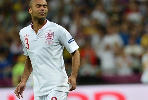 English defender Ashley Cole reacts after missing his shot