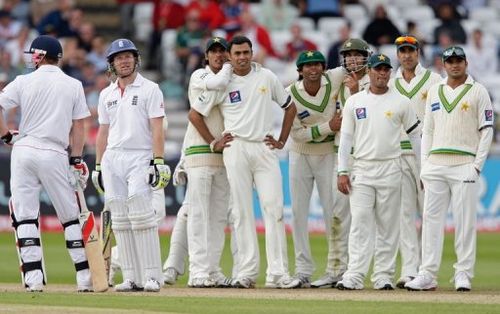 Pakistan cricketers watch as a Decision Review System ruling is made in a 2010 Test against England