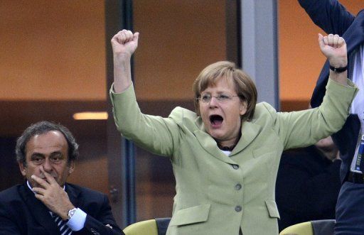 Chancellor Angela Merkel cheers on Germany in their victory over Greece last week