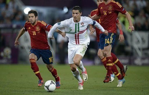 Portuguese forward Cristiano Ronaldo (C) vies with Spanish defender Jordi Alba