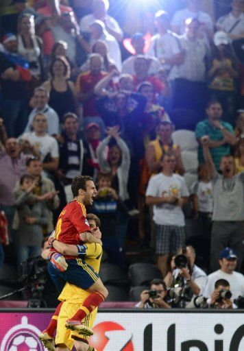 Spanish midfielder Cesc Fabregas (L) and Spanish goalkeeper Iker Casillas celebrate after winning the match