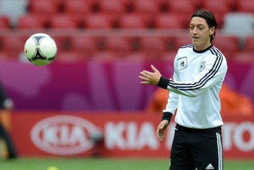 German midfielder Mesut Oezil throws the ball during a training session