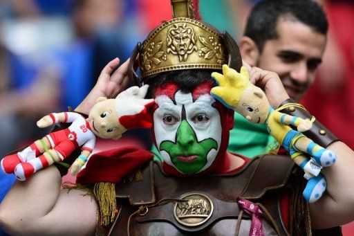 An Italian fan waits for the match to start