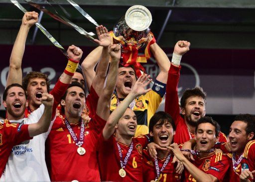 Spanish players celebrate with the trophy