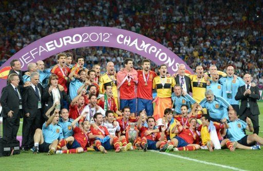 Spanish players pose with the trophy