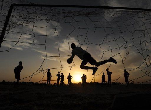 Afghan youngsters play football in the evening in the city of Herat in May