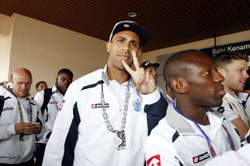 Anton Ferdinand gestures as QPR team members arrive in Malaysia for a friendly