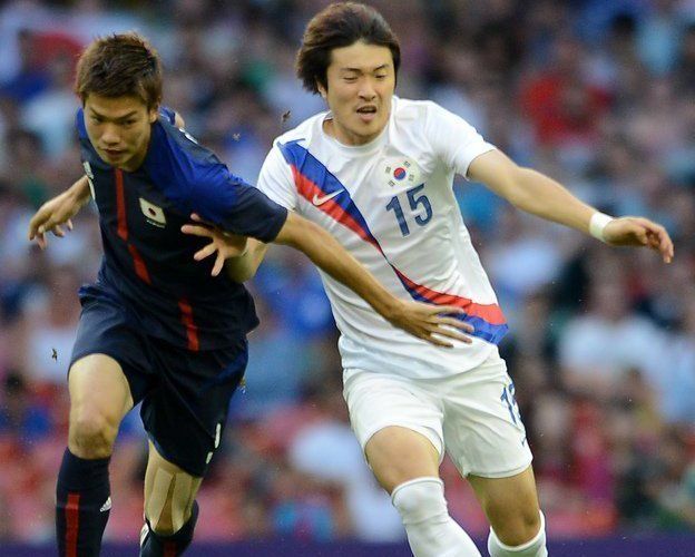 Park Jong-Woo (R) was barred from the medal ceremony after he held up a sign reading, 