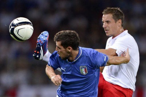 England&#039;s defender Phil Jagielka (R) vies for the ball with Italy&#039;s forward Mattia Destro