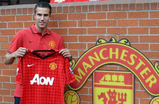 Robin Van Persie poses at Old Trafford in Manchester