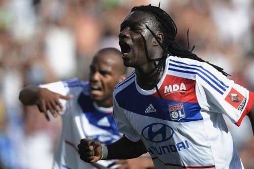 Lyon's forward Bafetimbi Gomis (R) celebrates after scoring a goal