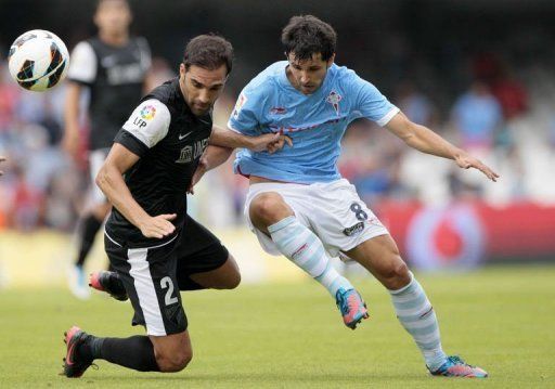 Celta&#039;s midfielder Alejandro Lopez (R) fights for the ball with Malaga&#039;s defender Jesus Gamez