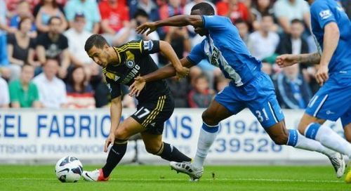 Chelsea midfielder Eden Hazard (left) vies for the ball with Wigan defender Maynor Figueroa