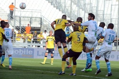 Marseille's French midfielder Andre-Pierre Gignac (3rd R) scores a goal