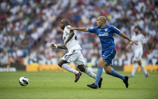 Real Madrid&#039;s midfielder Lass (L) fights for the balll with Valencia&#039;s French midfielder Sofiane Feghouli