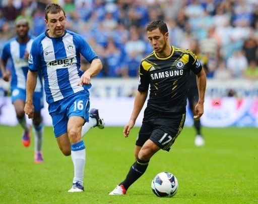 Chelsea midfielder Eden Hazard (R) set up two goals inside seven minutes of his side&#039;s league opener at Wigan
