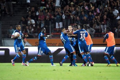 Lyon's Brazilian midfielder Michel Fernandes Bastos (3rdL) is congratulated by teammates