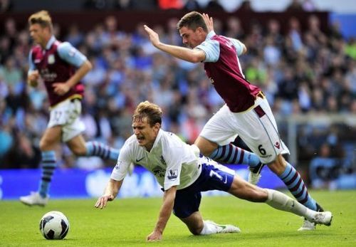 Everton's striker Nikica Jelavic (L) is fouled by Aston Villa's defender Ciaran Clark (R)