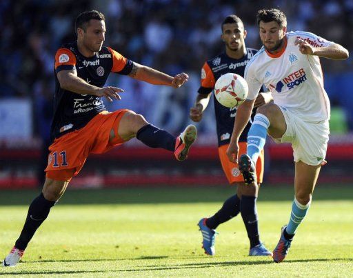 Marseille&#039;s Andre-Pierre Gignac (R) vies with Montpellier&#039;s Emmanuel Herrera