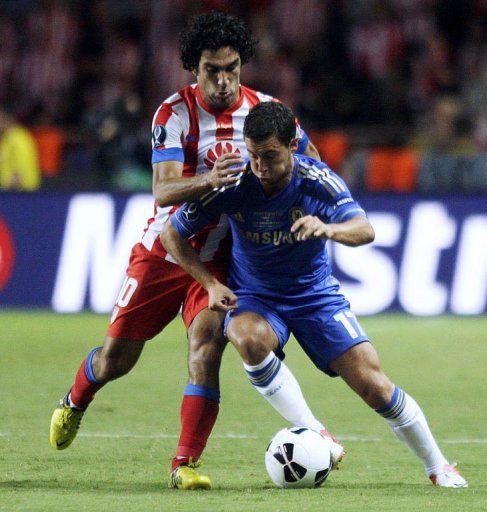 Chelsea&#039;s forward Eden Hazard (R) clashes with Atletico Madrid&#039;s forward Arda Turan