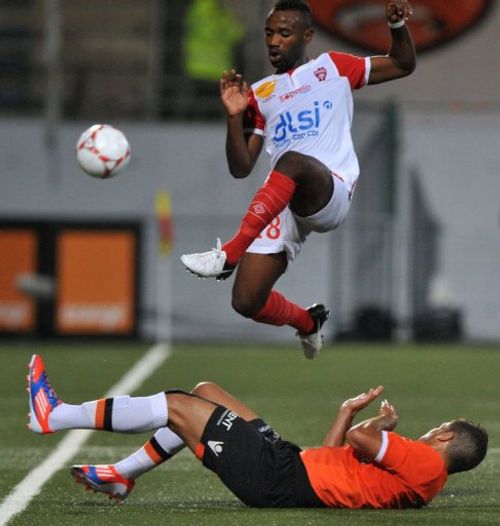 Nancy's midfielder Lossemy Karaboue jumps to avoid a tackle