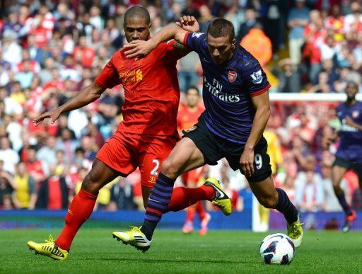 Lukas Podolski (right) vies with Liverpool&#039;s Glen Johnson