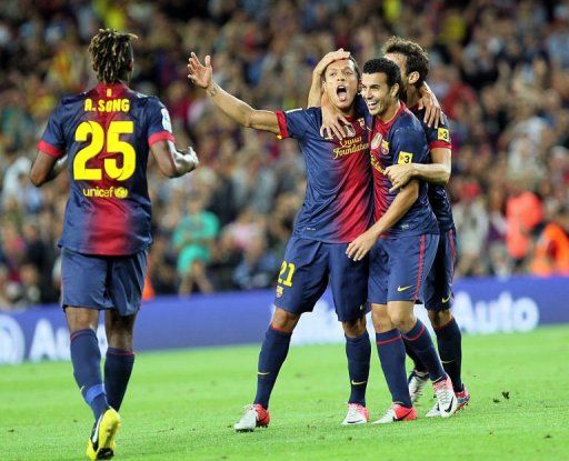 Barcelona&#039;s Brazilian defender Adriano Correia (C) is congratuled by teammate Pedro Rodriguez