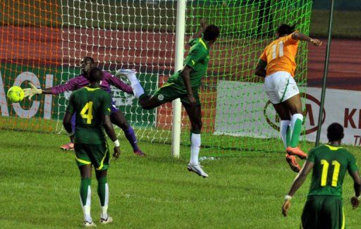 Ivory Coast&#039;s Didier Drogba (Top R) shoots against Senegal