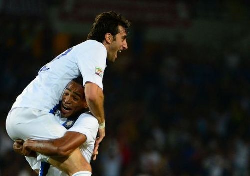 Inter Milan's Diego Milito (Top) celebrates with Alvaro Pereira after scoring