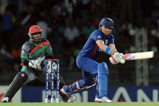 England cricketer Luke Wright (R) is watched by Afghan wicketkeeper Mohammad Shahzad