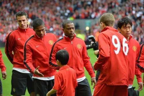 Manchester United defender Patrice Evra (3rd L) waits to shakes hands with Liverpool's Steven Gerrard (2nd right)