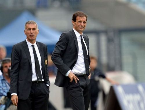 AC Milan's coach Massimiliano Allegri (R) grimaces next to his assistant Mauro Tassotti