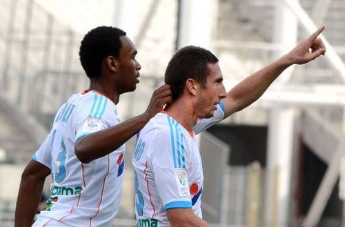 Marseille's Morgan Amalfitano (R) celebrates with Julio Nkoulou