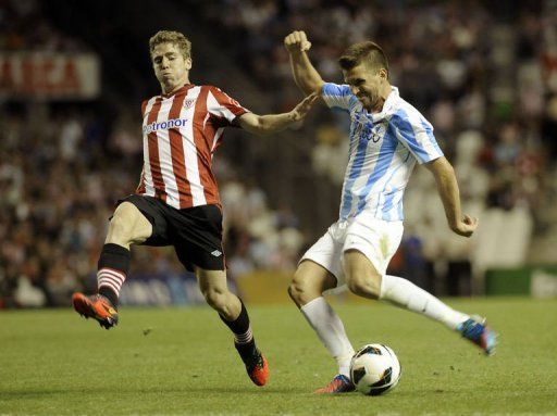Malaga&#039;s Ignacio Camacho (R) vies with Athletic Bilbao&#039;s Iker Muniain