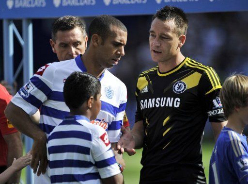 Anton Ferdinand (L) avoids shaking hands with John Terry ahead of their Premier League match this month