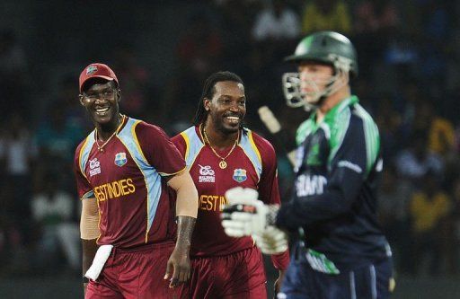 West Indies cricketer Chris Gayle (C) celebrates with his captain Darren Sammy (L)