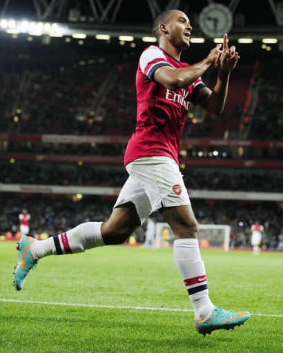 Arsenal&#039;s Theo Walcott celebrates scoring the sixth goal