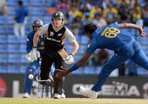 Angelo Mathews (right) tries to stop a shot by New Zealand's Rob Nicol