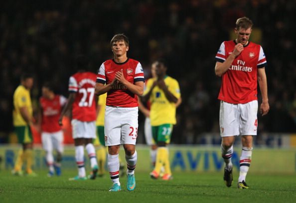 NORWICH, ENGLAND - OCTOBER 20: Andrey Arshavin and Per Mertesacker of Arsenal look dejected in defeat after the Barclays Premier League match between Norwich City and Arsenal at Carrow Road on October 20, 2012 in Norwich, England.