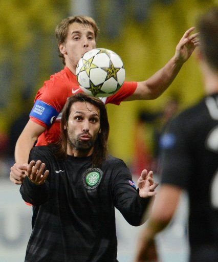 Giorgos Samaras of Celtic (bottom) vies for the ball with Juan Insaurralde of Spartak