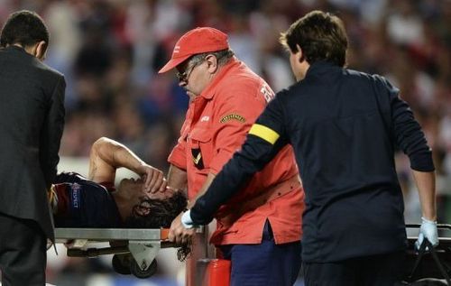 Barcelona's captain Carles Puyol is stretchered out