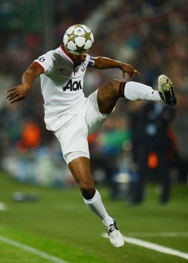 Manchester United&#039;s Patrice Evra heads the ball