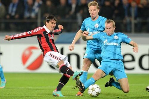 Aleksandr Anyukov (R) of FC Zenit St Petersburg fights for the ball against Bojan Krkic (L) of AC Milan