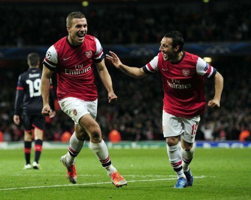 Arsenal&#039;s Santi Cazorla (R) runs to congratulate Lukas Podolski (L)