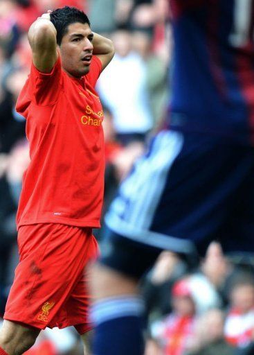 Liverpool&#039;s Luis Suarez reacts to a missed chance