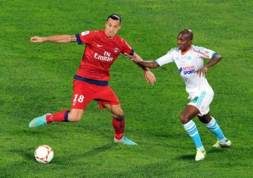 Paris Saint-Germain's Zlatan Ibrahimovic (L) vies with Marseille's Charles Kabore