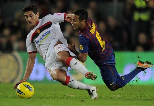 Real Mallorca midfielder Joao Victor (left) holds off a Barcelona player during a Spanish league match in October 2011