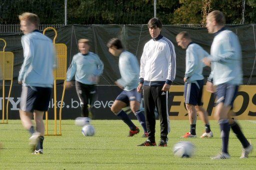 Germany&#039;s head coach Joachim Loew (C) oversees a training session of the German national soccer team