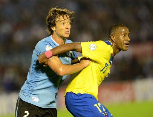 Diego Lugano (left) wants Uruguay to put physical pressure on Argentina in tonight&#039;s World Cup qualifier